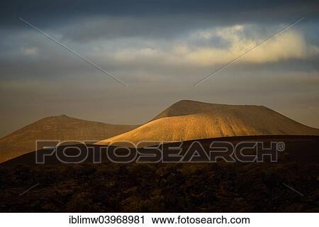 Stock Image - "First morning light, Montanas del Fuego, Timanfaya National Park, Lanzarote, Canary Islands, Spain, Europe". Fotosearch