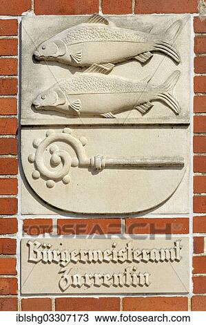 Stock Image - "Fish reliefs on the facade of the mayor's office, Zarrentin am Schaalsee, Mecklenburg-Western Pomerania, Germany, Europe". Fotosearch