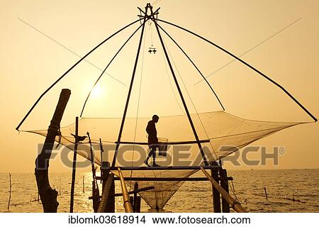 "Fisherman holding a landing net in a Chinese fishing net at sunrise, Vembanad lake, Kerala, India, Asia" View Large Photo Image Picture - "Fisherman holding a landing net in a Chinese fishing net at sunrise, Vembanad lake, Kerala, India, Asia". Fotosearch