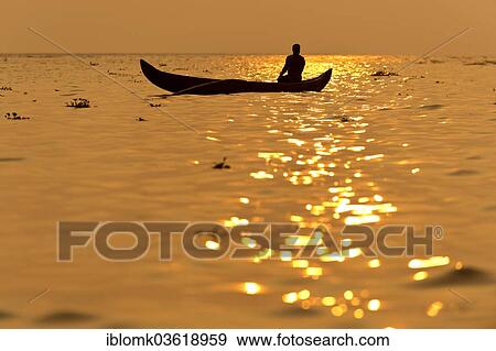 "Fisherman in his boat at sunrise, Vembanad lake, Kerala, India, Asia" View Large Photo Image Stock Photo - "Fisherman in his boat at sunrise, Vembanad lake, Kerala, India, Asia". Fotosearch