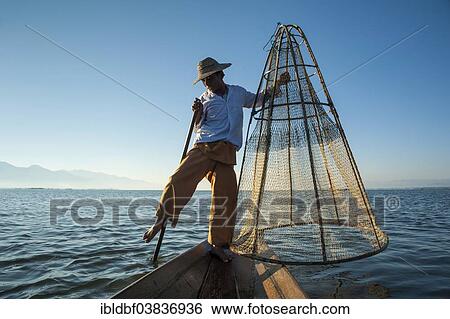 "Fisherman, leg rower with a traditional basket on the canoe, Inle Lake, Shan State, Myanmar, Asia" View Large Photo Image Stock Photograph - "Fisherman, leg rower with a traditional basket on the canoe, Inle Lake, Shan State, Myanmar, Asia". Fotosearch