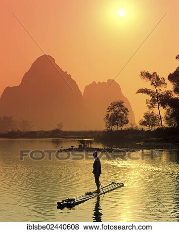 "Fisherman on a bamboo raft on the Li Jiang River, karst mountain landscape near Yangshuo, Guilin, Guangxi, China, Asia" View Large Photo Image Stock Photo - "Fisherman on a bamboo raft on the Li Jiang River, karst mountain landscape near Yangshuo, Guilin, Guangxi, China, Asia". Fotosearch
