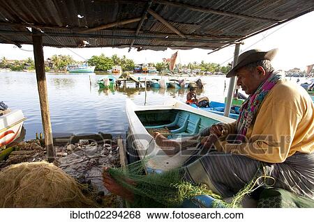 Stock Photo - "Fisherman repairing a net, Negombo, Sri Lanka, Asia". Fotosearch