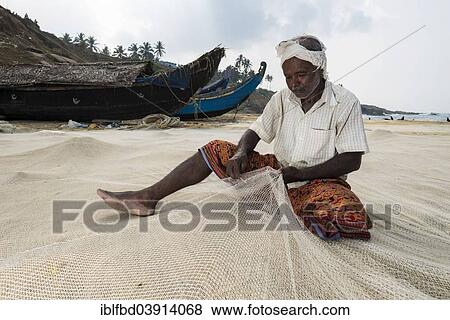"Fisherman repairing fishing nets on the beach, Vizhinjam, Kerala, India, Asia" View Large Photo Image Stock Photo - "Fisherman repairing fishing nets on the beach, Vizhinjam, Kerala, India, Asia". Fotosearch
