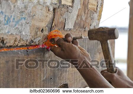 "Fisherman repairing his boat in the harbour of Rameshwaram, India, Asia" View Large Photo Image Stock Photograph - "Fisherman repairing his boat in the harbour of Rameshwaram, India, Asia". Fotosearch