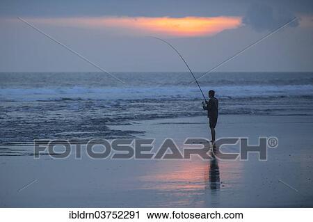 Stock Image - "Fisherman standing on the beach, Kerambitan, Bali, Indonesia, Asia". Fotosearch