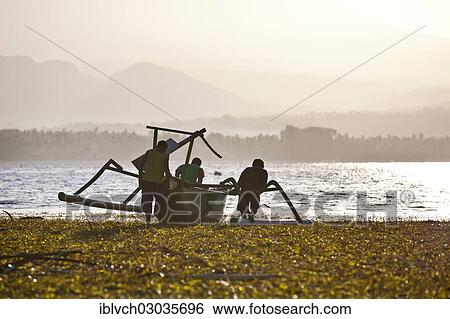 Stock Photograph - "Fisherman with a fishing boat with outriggers, Gili Islands, Bali, Indonesia, Asia". Fotosearch
