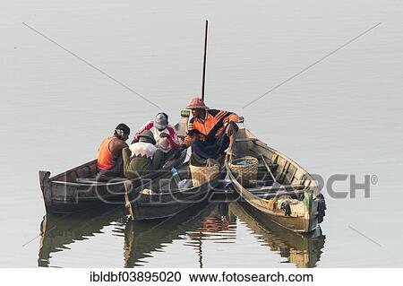 Stock Image - "Fishermen in their boats in the morning light, Thaungthaman Lake, Amarapura, Mandalay Division, Myanmar, Asia". Fotosearch