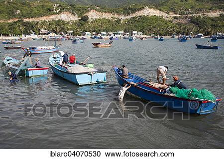 Stock Image - "Fishermen in their fishing boats unloading their catch, Vinh Hy Bay, South China Sea, Vietnam, Asia". Fotosearch
