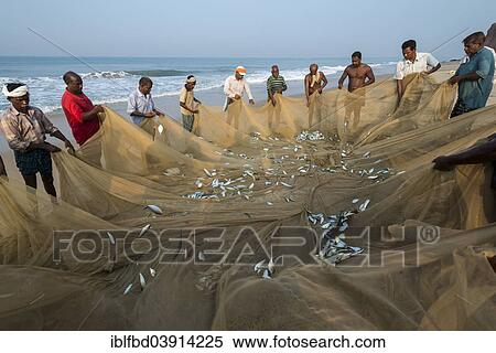 Stock Photography - "Fishermen inspecting fishing nets, Varkala, Kerala, India, Asia". Fotosearch