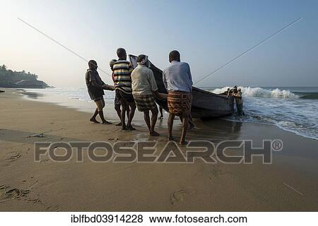 Stock Photo - "Fishermen pulling a boat onto the beach, Varkala, Kerala, India, Asia". Fotosearch