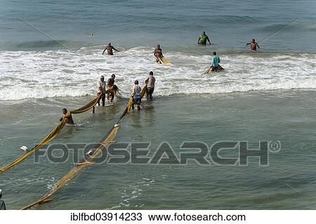 "Fishermen pulling fishing nets onto the beach, Varkala, Kerala, India, Asia" View Large Photo Image Stock Image - "Fishermen pulling fishing nets onto the beach, Varkala, Kerala, India, Asia". Fotosearch