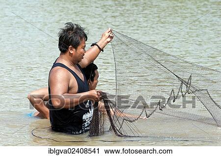 "Fishermen putting out a fishing net in the Sangkae river, Battambang, Cambodia, Southeast Asia, Asia" View Large Photo Image Stock Image - "Fishermen putting out a fishing net in the Sangkae river, Battambang, Cambodia, Southeast Asia, Asia". Fotosearch