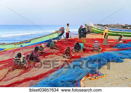 Picture - "Fishermen repairing nets on the beach, Arabian Sea, Varkala, Kerala, South India, India, Asia". Fotosearch