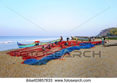 "Fishermen repairing nets on the beach, Arabian Sea, Varkala, Kerala, South India, India, Asia" View Large Photo Image Stock Image - "Fishermen repairing nets on the beach, Arabian Sea, Varkala, Kerala, South India, India, Asia". Fotosearch