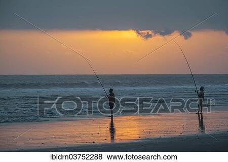 Stock Photo - "Fishermen standing on the beach, Kerambitan, Bali, Indonesia, Asia". Fotosearch