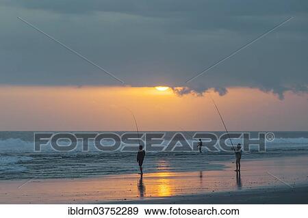 Stock Photo - "Fishermen standing on the beach, Kerambitan, Bali, Indonesia, Asia". Fotosearch