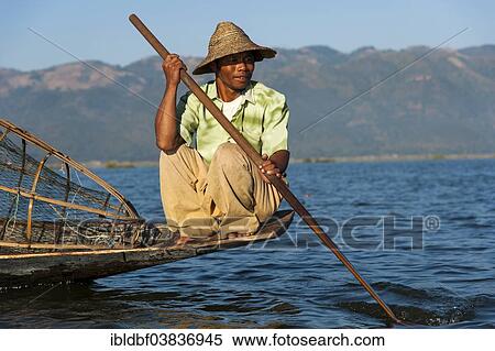 Stock Photography - "Fishermen with a traditional basket, sitting on the canoe, Inle Lake, Shan State, Myanmar, Asia". Fotosearch