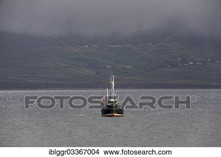 Picture - "Fishing boat off the coast, Ballinskelligs, Ring of Kerry, Waterville, County Kerry, Ireland, Europe". Fotosearch
