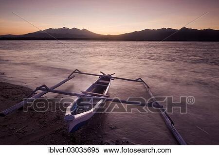 Stock Photography - "Fishing boat with outriggers at sunrise, Gili Islands, Bali, Indonesia, Asia". Fotosearch