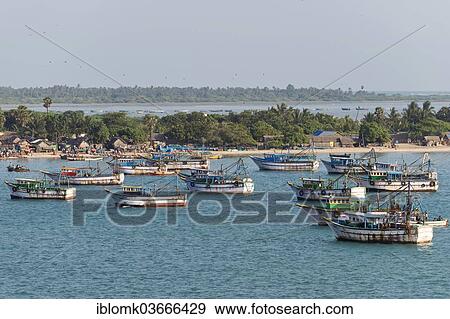 Stock Photo - "Fishing boats and fishermen's huts on the coast, Rameswaram, Pamban Island, Tamil Nadu, India, Asia". Fotosearch