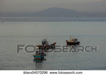 "Fishing boats at dawn, in the bay of Mui Ne, Vietnam, Asia" View Large Photo Image Stock Photograph - "Fishing boats at dawn, in the bay of Mui Ne, Vietnam, Asia". Fotosearch