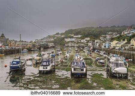 Stock Photo - "Fishing boats in the harbor at low tide, Looe, Cornwall, England, United Kingdom, Europe". Fotosearch