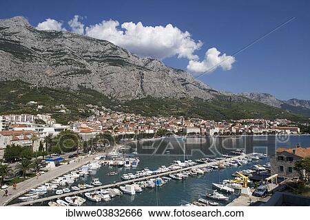Stock Photograph - "Fishing boats in the harbour, the Biokovo Mountains at the back, Promajna, Makarska Riviera, Dalmatia, Croatia, Europe". Fotosearch