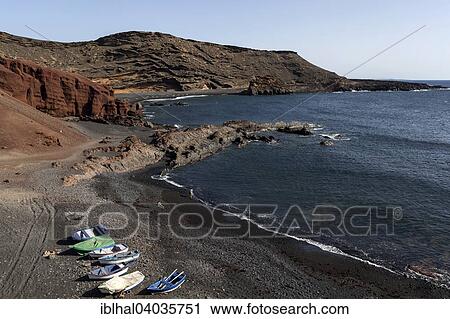 "Fishing boats on the black beach of El Golfo, volcano crater, Lanzarote, Canary Islands, Spain, Europe" View Large Photo Image Stock Image - "Fishing boats on the black beach of El Golfo, volcano crater, Lanzarote, Canary Islands, Spain, Europe". Fotosearch