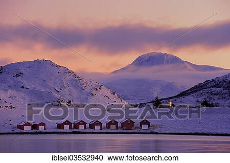 "Fishing huts beside a fjord in front of a mountain peak at the blue hour, Tromso, ‪Troms, Northern Norway, Norway, Europe" View Large Photo Image Stock Image - "Fishing huts beside a fjord in front of a mountain peak at the blue hour, Tromso, ‪Troms, Northern Norway, Norway, Europe". Fotosearch