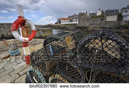 "Fishing nets, lobster traps and ropes lying on the pier of Portsoy, Banffshire, Scotland, United Kingdom, Europe" View Large Photo Image Stock Image - "Fishing nets, lobster traps and ropes lying on the pier of Portsoy, Banffshire, Scotland, United Kingdom, Europe". Fotosearch
