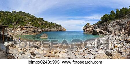 "Fishing village and hidden cove of Cala Deia, Deia, Serra de Tramuntana, northwest coast, Mallorca, Balearic Islands, Mediterranean Sea, Spain, Europe" View Large Photo Image Stock Image - "Fishing village and hidden cove of Cala Deia, Deia, Serra de Tramuntana, northwest coast, Mallorca, Balearic Islands, Mediterranean Sea, Spain, Europe". Fotosearch