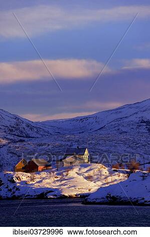 Stock Photograph - "Fishing village beside a fjord with wintry mountains, Sommeroya, Tromso, â€ªTroms, Northern Norway, Norway, Europe". Fotosearch