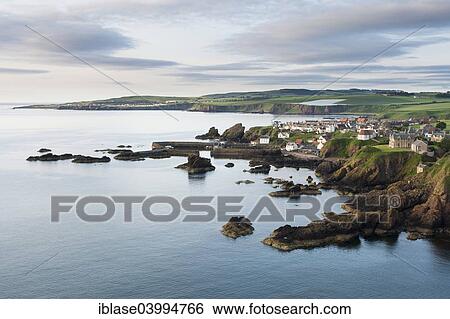 Stock Photograph - "Fishing village of St Abbs on the east coast, town of Eyemouth behind at left, Berwickshire, Scotland, United Kingdom, Europe". Fotosearch