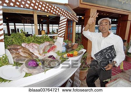 "Fishmonger beckoning in a seafood restaurant, Dahab, Sinai Peninsula, Egypt, Africa" View Large Photo Image Stock Image - "Fishmonger beckoning in a seafood restaurant, Dahab, Sinai Peninsula, Egypt, Africa". Fotosearch