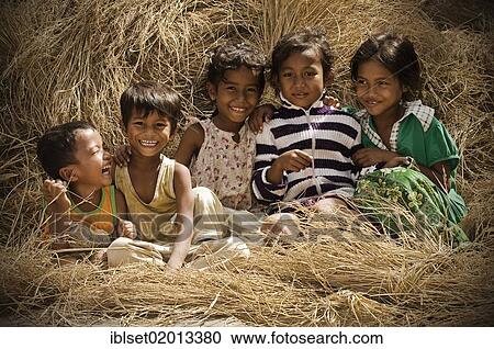 "Five laughing children sitting on rice straw, Cambodia, Southeast Asia, Asia" View Large Photo Image Stock Image - "Five laughing children sitting on rice straw, Cambodia, Southeast Asia, Asia". Fotosearch