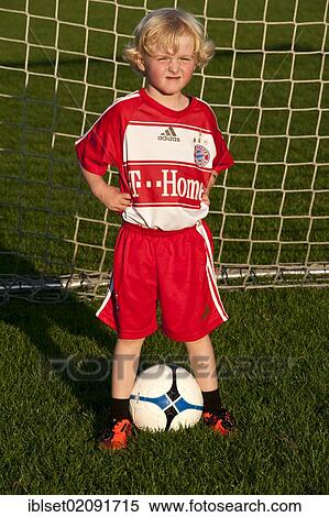"Five-year-old boy wearing a FC Bayern Munich soccer dress, standing in a soccer goal with a soccer ball" View Large Photo Image Stock Photography - "Five-year-old boy wearing a FC Bayern Munich soccer dress, standing in a soccer goal with a soccer ball". Fotosearch