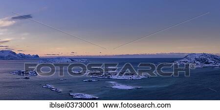 Stock Image - "Fjord with islands during the blue hour, Sommeroya, Tromso, â€ªTroms, Northern Norway, Norway, Europe". Fotosearch