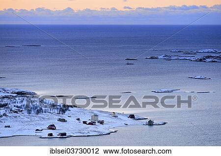 Stock Image - "Fjord with islands during the blue hour, Sommeroya, Tromso, â€ªTroms, Northern Norway, Norway, Europe". Fotosearch