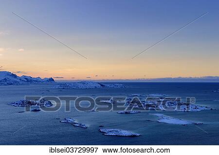 Stock Photo - "Fjord with islands during the blue hour, Sommeroya, Tromso, â€ªTroms, Northern Norway, Norway, Europe". Fotosearch
