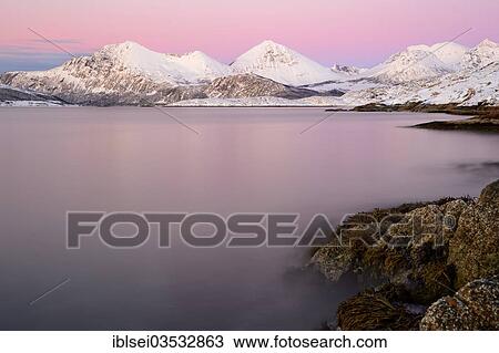 "Fjord with stones in front of a mountain range in the evening light, Tromso, ‪Troms, Northern Norway, Norway, Europe" View Large Photo Image Stock Image - "Fjord with stones in front of a mountain range in the evening light, Tromso, ‪Troms, Northern Norway, Norway, Europe". Fotosearch
