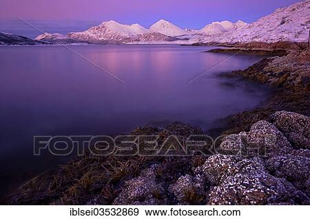 "Fjord with stones in front of a mountain range in the evening light, Tromso, ‪Troms, Northern Norway, Norway, Europe" View Large Photo Image Stock Photo - "Fjord with stones in front of a mountain range in the evening light, Tromso, ‪Troms, Northern Norway, Norway, Europe". Fotosearch