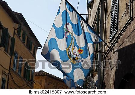 Flag of a contrada district in an alley of the historic town centre, Capitana Contrada dell'Onda, Captain Contrada of the Sea-Wave, Palio, UNESCO World Cultural Heritage Site, Siena, Tuscany region, province of Siena, Italy, Europe View Large Photo Image Stock Photo - Flag of a contrada district in an alley of the historic town centre, Capitana Contrada dell'Onda, Captain Contrada of the Sea-Wave, Palio, UNESCO World Cultural Heritage Site, Siena, Tuscany region, province of Siena, Italy, Europe. Fotosearch