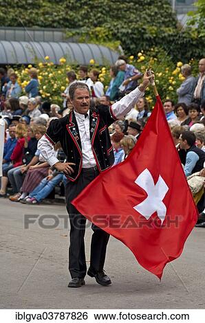 "Flag-waver with a Swiss flag at a costume parade, Interlaken, Canton of Bern, Switzerland, Europe" View Large Photo Image Stock Photograph - "Flag-waver with a Swiss flag at a costume parade, Interlaken, Canton of Bern, Switzerland, Europe". Fotosearch