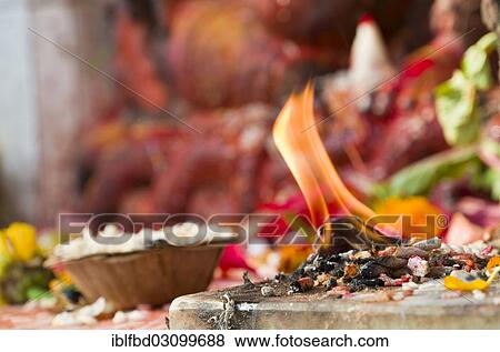 Stock Photo - "Flame burning in front of a Ganesha shrine, Kathmandu, Kathmandu District, Bagmati Zone, Nepal, Asia". Fotosearch