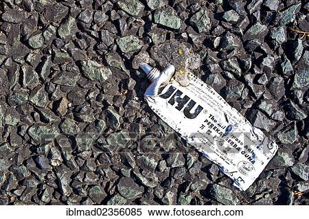 Flat glue tube lying on black concrete View Large Photo Image Stock Photography - Flat glue tube lying on black concrete. Fotosearch