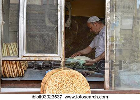 "Flatbread baker in a bakery, Uyghur Muslim Quarter, Kashgar, Seidenstrasse, Xinjiang, China, People's Republic of China, Asia" View Large Photo Image Stock Photo - "Flatbread baker in a bakery, Uyghur Muslim Quarter, Kashgar, Seidenstrasse, Xinjiang, China, People's Republic of China, Asia". Fotosearch