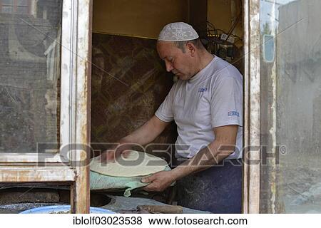 "Flatbread baker in a bakery, Uyghur Muslim Quarter, Kashgar, Seidenstrasse, Xinjiang, China, People's Republic of China, Asia" View Large Photo Image Stock Photo - "Flatbread baker in a bakery, Uyghur Muslim Quarter, Kashgar, Seidenstrasse, Xinjiang, China, People's Republic of China, Asia". Fotosearch