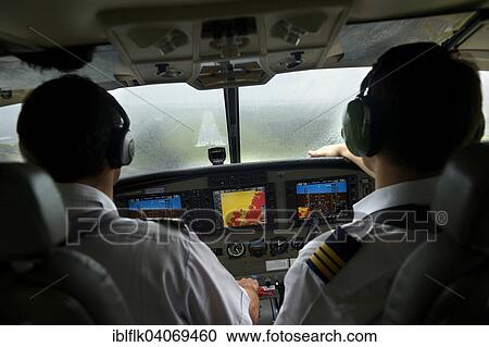 Stock Image - "Flight deck, airplane landing in rain, Simeulue, Indonesia, Asia". Fotosearch