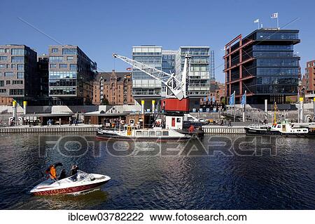 Stock Image - "Floating promenade along the Sandtorhafen with view through to the Speicherstadt district, HafenCity, Hamburg, Germany, Europe". Fotosearch